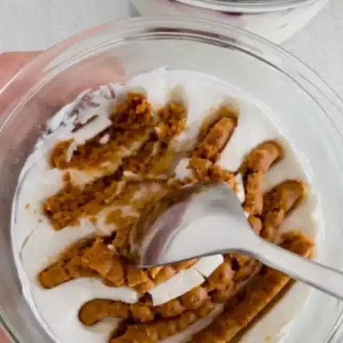 Slice of vegan Japanese yogurt cheesecake on a white plate with fresh berries and citrus zest